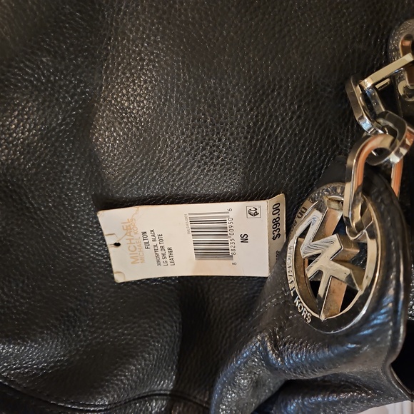 Micheal Kors satchel black all leather gold emblem accent.  It's roomy and nice. - Picture 6 of 8